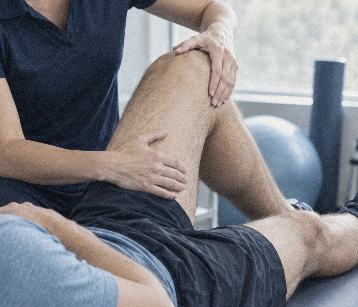 A practitioner assessing movement and recovery